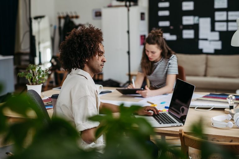 Young colleagues working together in startup company