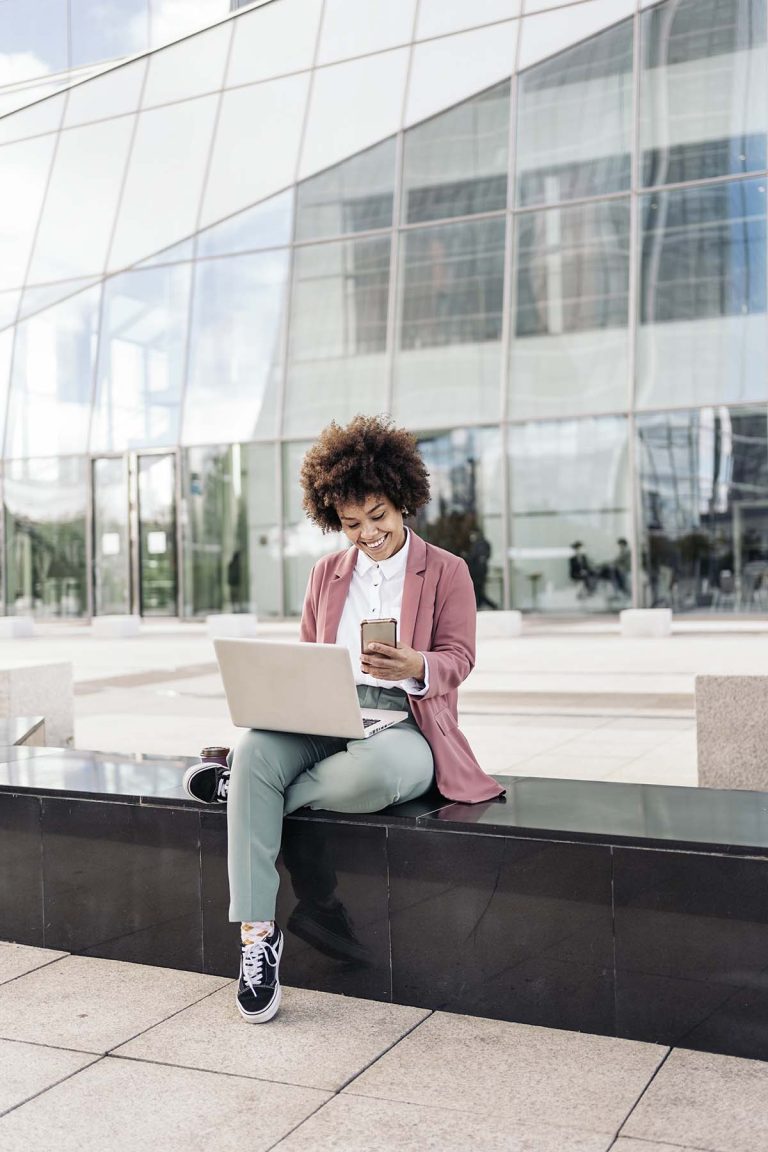 business-woman-using-laptop-outdoors-7N5DSFH